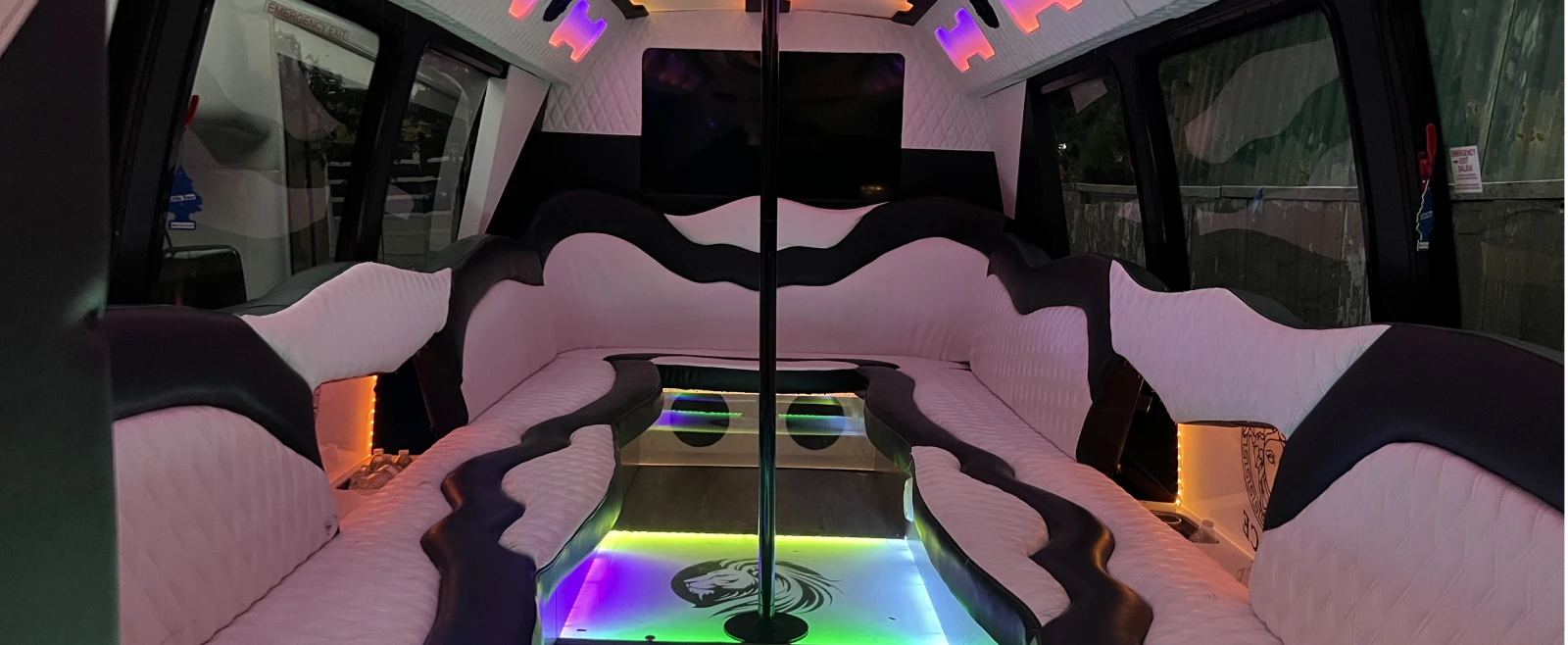 Party Bus Rental Chicago 11 Full-width luxury party bus interior with LED lighting, leather seating, and bar area